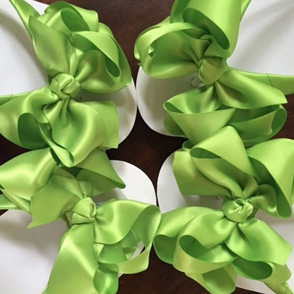 Large apple green coloured bows on high wedge heel flip flops