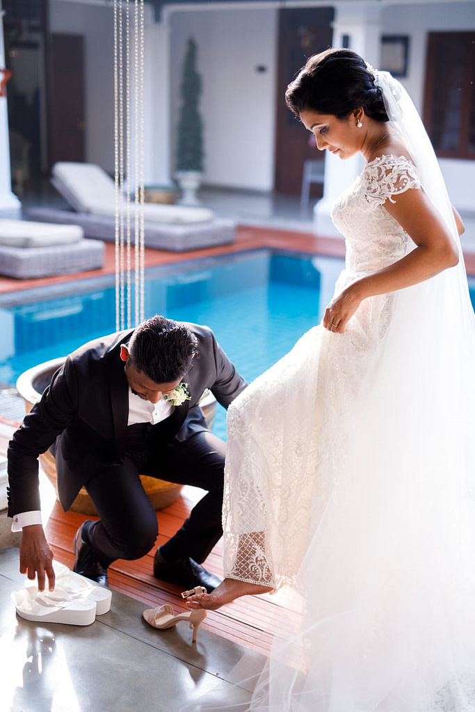 Photo Session opportunity when husband slips new Bride's Bridal Flip Flops onto her feet