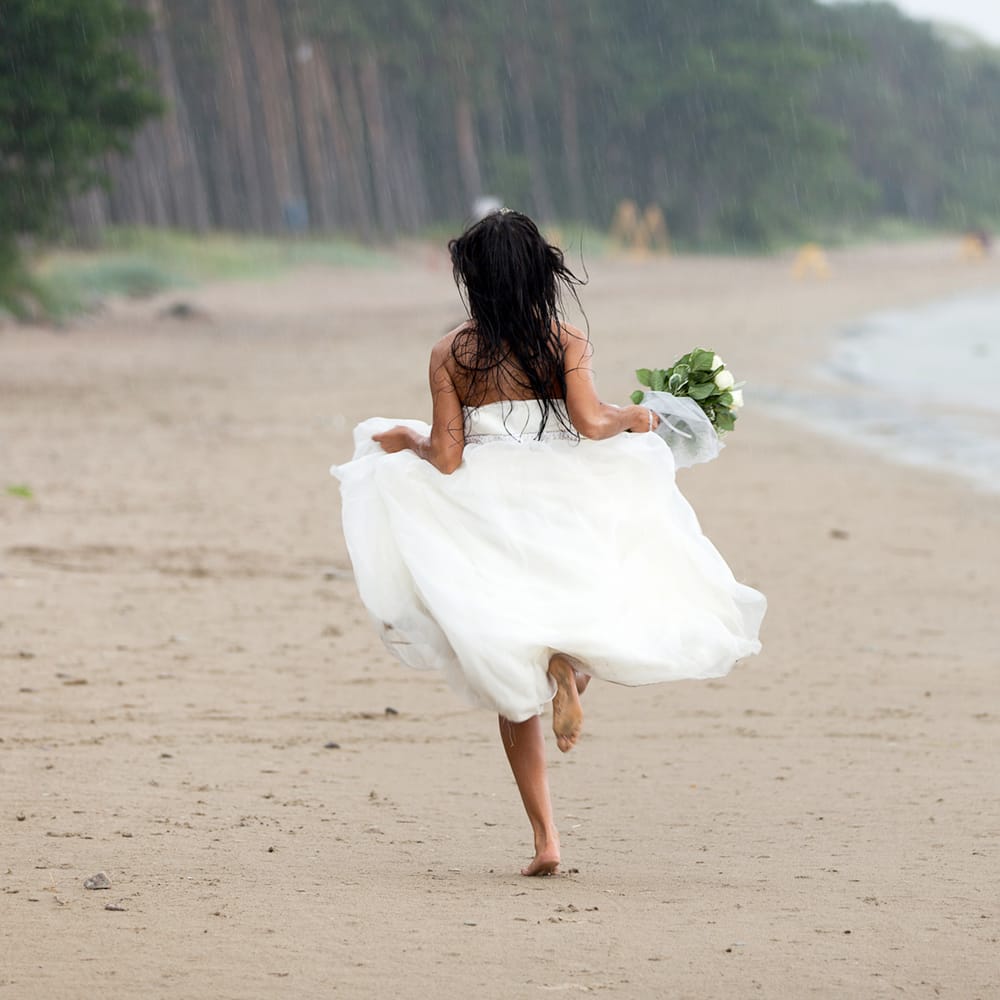 Bride running along the Beach