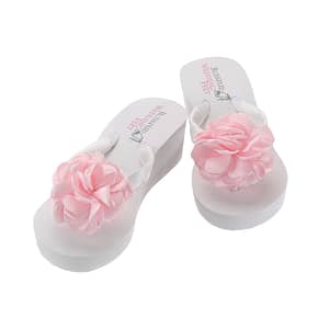 High wedge heeled flip flops with large pink satin roses